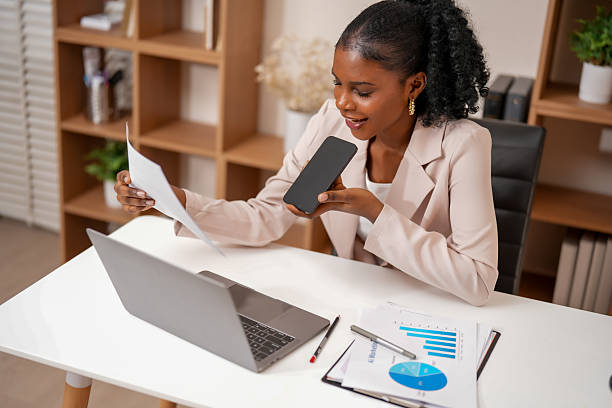istock Woman engages productive work session, utilizing technology to enhance her creative collaboration. She reviews documents while connecting with data her smartphone, showcasing integration 2232914623