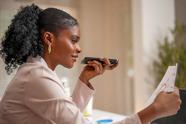 Woman engages in creative collaboration using technology, connecting through her smartphone while reviewing important documents. This scene captures essence of modern work life