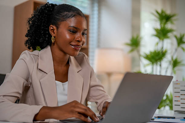 istock Woman engages in creative collaboration with technology while working on laptop in bright office space. Her focused expression reflects strong connection to her tasks 2232914639