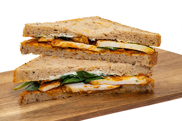 A chicken tikka curry sandwich - white background