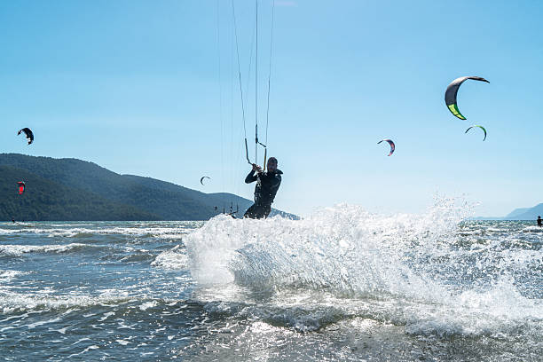 Kite surfer performing jump trick above the water, Turkey