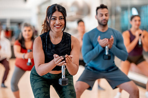 istock Diverse Group Fitness Class Using Dumbbells for Strength Training 2232922563