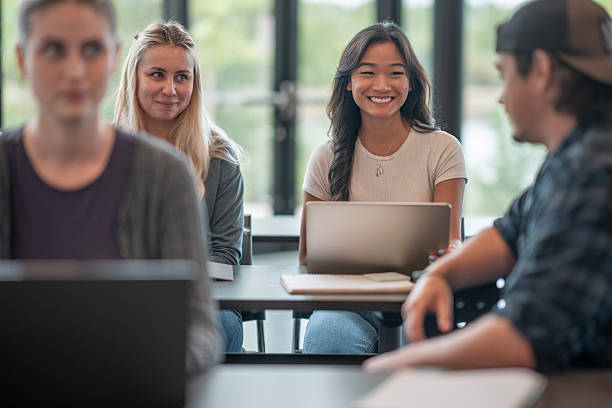istock Group of Diverse Students Collaborating in a Bright Classroom with Smiling Faces 2232926663