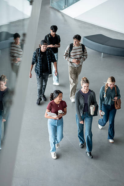 istock Diverse Group of Students Walking Together in Modern University Hallway 2232926757