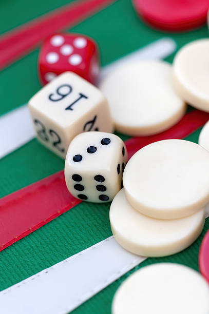 istock backgammon green felt with red and white, with dice rolling, gambling luck and skill game 2232928313