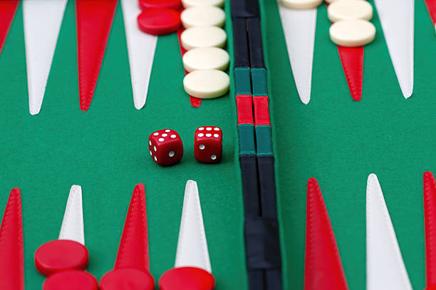 Backgammon game set up on the ground under the gravel facing the sea