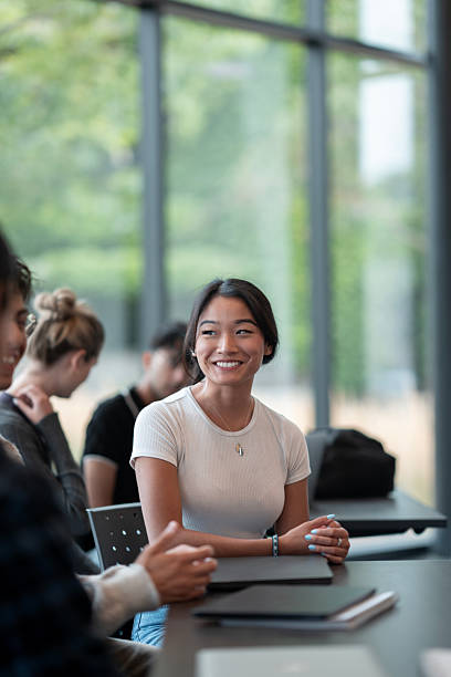 istock Smiling Young Woman Interacting in a Modern Study Group at the Library 2232928962