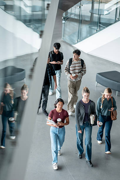 istock Diverse Group of University Students Walking Through Modern Campus Hallway 2232929007