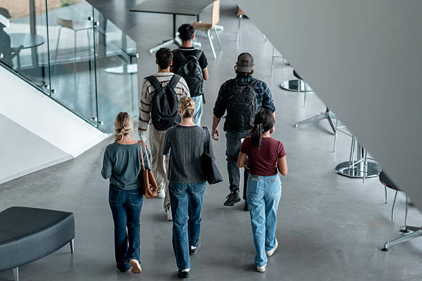 istock Group of Diverse Students Walking Together Through a Modern Building Interior 2232929052