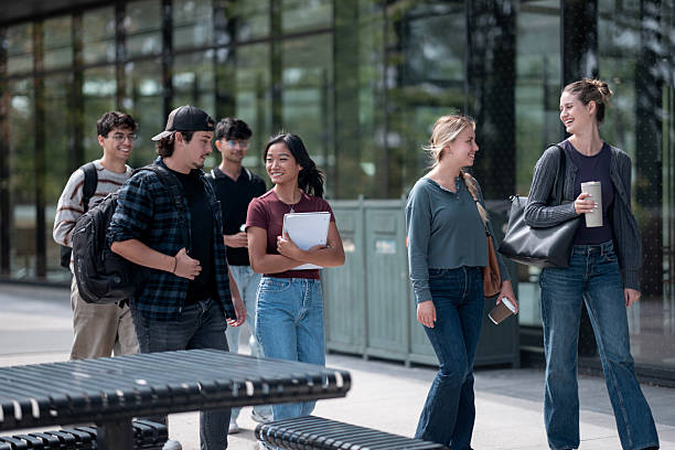 istock Group of Young Adults Walking Together Outside a Campus Building 2232929721