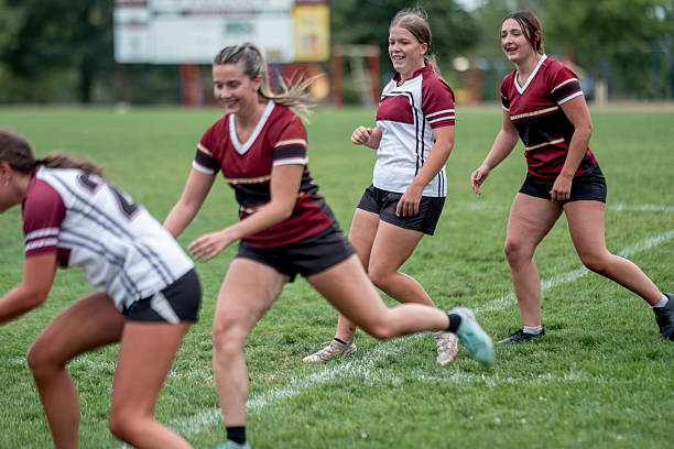 istock Women Playing Team Rugby on a Green Field During Daytime 2232930170