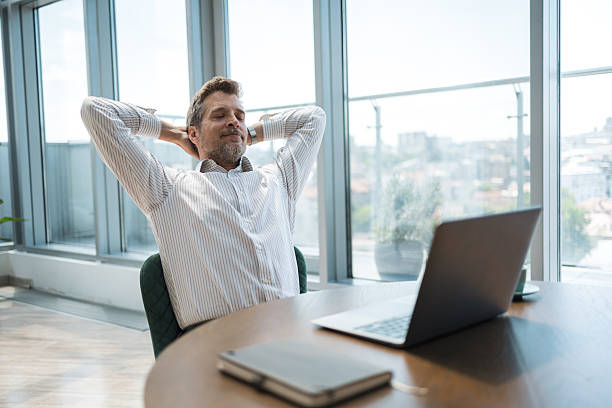 istock Businessman relaxing with confidence at desk in modern office setting 2232930317