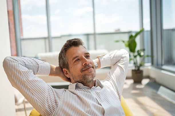 istock Relaxed businessman enjoying a break in a modern sunlit workspace 2232930328