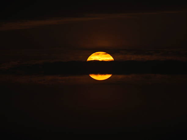 istock Closeup of the sun with sunspots partially covered with clouds 2232937461