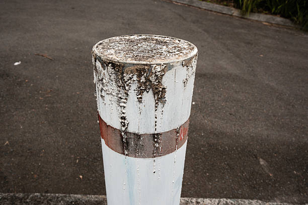 High angle view of an old white metal bollard.