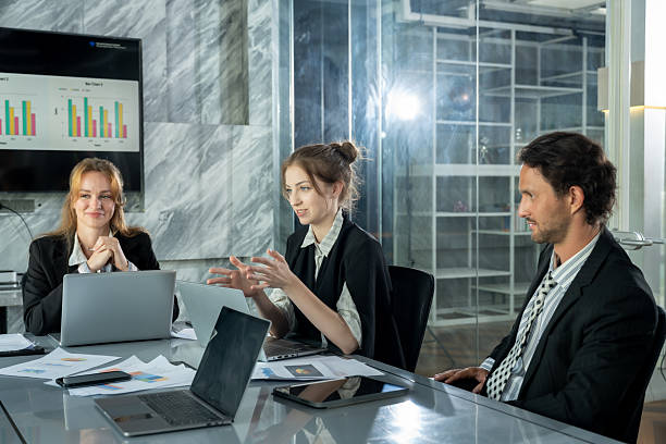 istock three multiracial business people having conversation around meeting table while female executive leading discussion on business strategy teamwork and collaboration for office work in workplace 2232946039