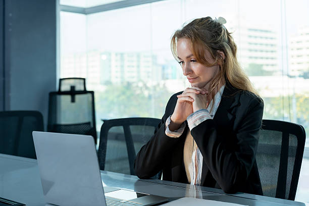istock Caucasian female executive thinking while looking at laptop screen during solo work session in modern office, planning strategy and analyzing business information for decision making 2232946074