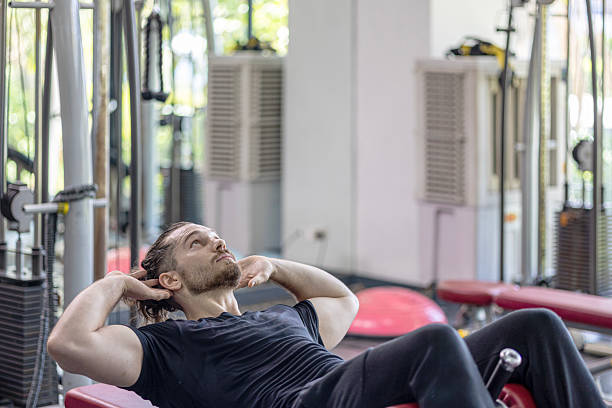 istock Demonstration from a young trainer for weight lifting and sit up 2232947865