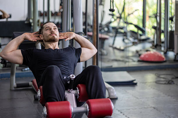 istock Demonstration from a young trainer for weight lifting and sit up 2232947869