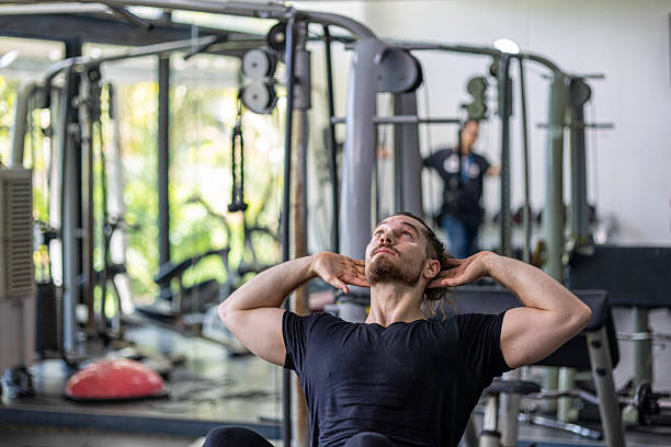 istock Demonstration from a young trainer for weight lifting and sit up 2232947874