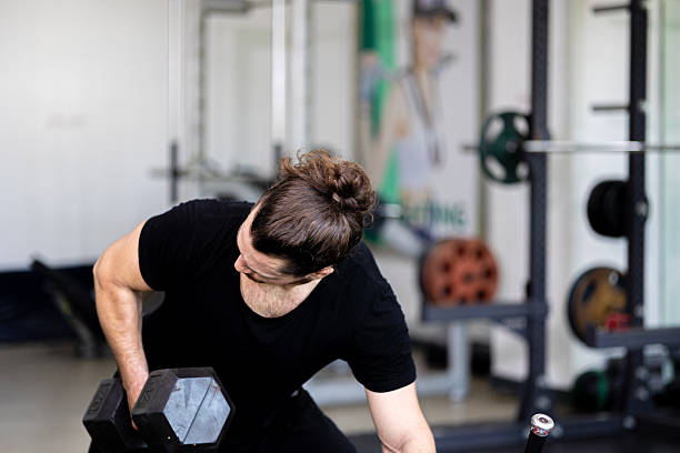 istock Demonstration from a young trainer for weight lifting and sit up 2232947888