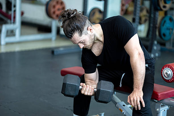 istock Demonstration from a young trainer for weight lifting and sit up 2232947896