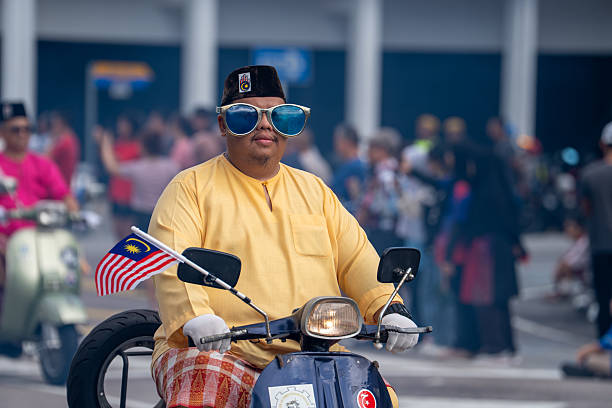 Batu Pahat, Johor, Malaysia - August 31, 2025: Multiracial Malaysian people with traditional attire march during 68th Independence Day celebration in Batu Pahat, Malaysia. An editorial image capturing the vibrant Malaysia Independence Day (Hari Kemerdekaan) celebration held in 2025 at Johor, featuring patriotic crowds, national flags (Jalur Gemilang), and traditional cultural performances that reflect the unity and diversity of the Malaysian people.