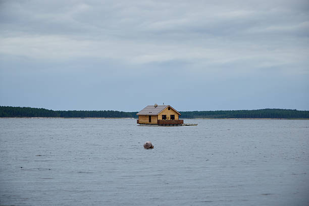 A charming yellow cabin by calm waters, surrounded by lush nature, perfect for stunning serene landscapes