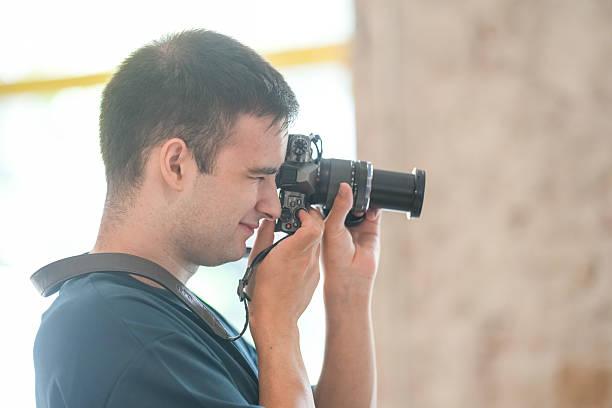 istock A man is taking a picture with a camera 2232954283