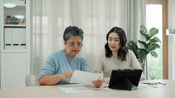 istock Mother and daughter calculating expenses at home 2232955932