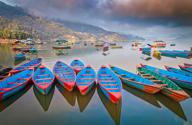 istock Colorful Boats Reflected on a Misty Lake Phew 2232956817