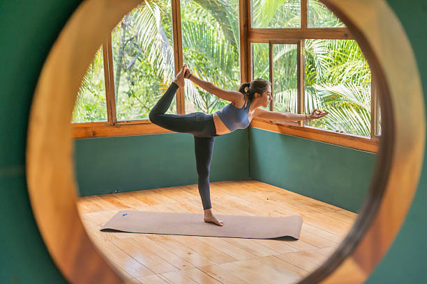 istock Young woman performing various yoga poses such as warrior, lotus, tree pose, cobra pose, etc. 2232958053