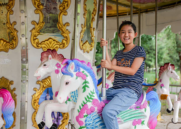 Little girl playing merry-go-round
