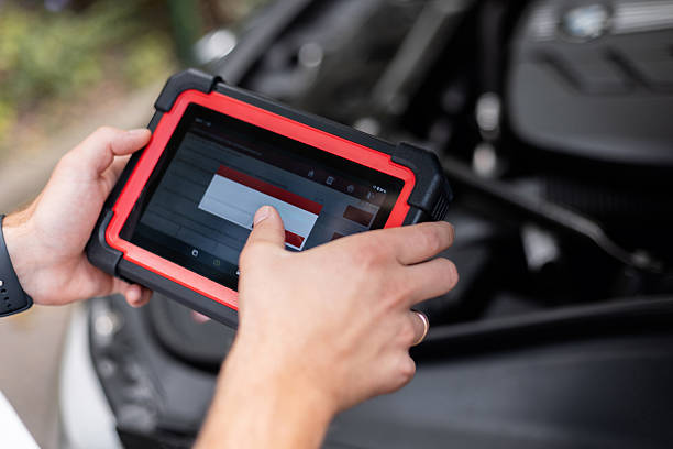 istock Hands holding a modern car diagnostic tool during vehicle inspection. Mechanic using a digital diagnostic scanner to check car systems inside the vehicle. 2232959912