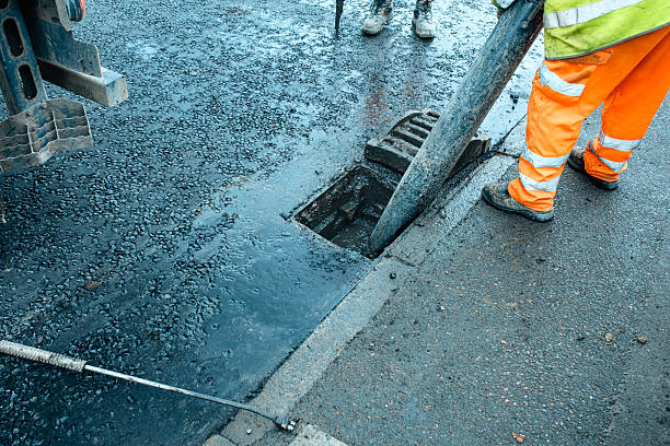istock Roadworkers opened clogged road gully and cleaning it from debris and dirt using vac-ex and power jet wash 2232962493