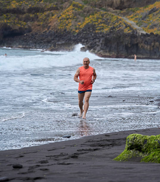 istock Man running on volcanic beach 2232962822