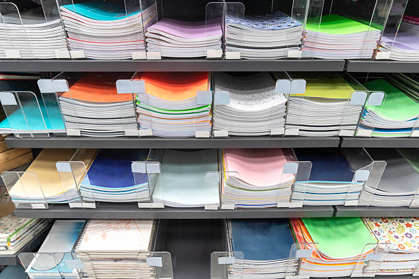 istock Organized stationery shelf in a store, filled with notebooks. 2232962883