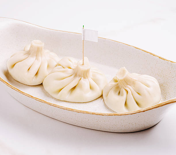 istock Steaming dumplings or khinkali served in a white dish at a restaurant 2232963056