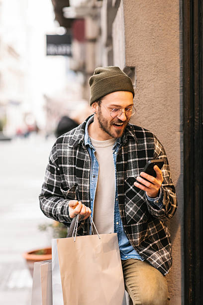 istock Happy man with shopping bags 2232963175