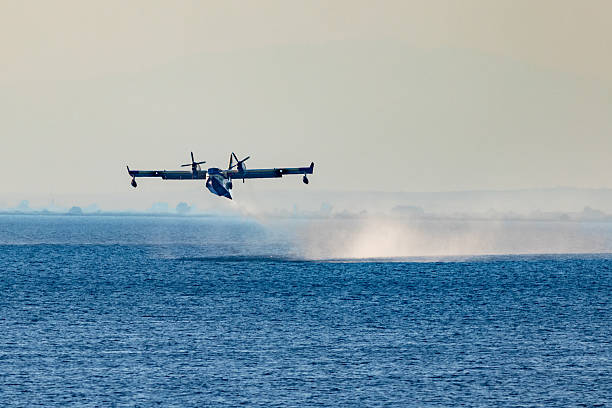 Thermaic Gulf, Greece – 26 June 2025: A firefighting amphibious aircraft is seen taking off after scooping water from the sea during operations to combat nearby wildfires. The aircraft, specially designed for aerial firefighting, creates a dramatic spray trail across the surface of the Aegean waters. Greece frequently deploys such planes during the dry summer season to contain wildfires that threaten forests, rural communities, and infrastructure.