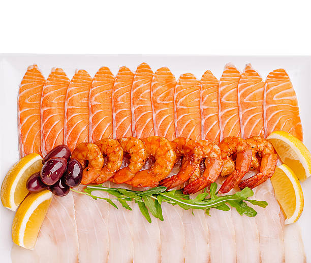 Seafood platter with shrimp, salmon, and lemon garnishes