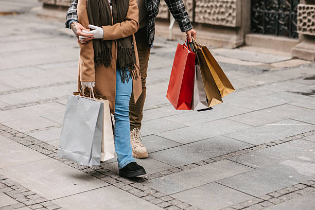istock Couple holding shopping bags 2232963446