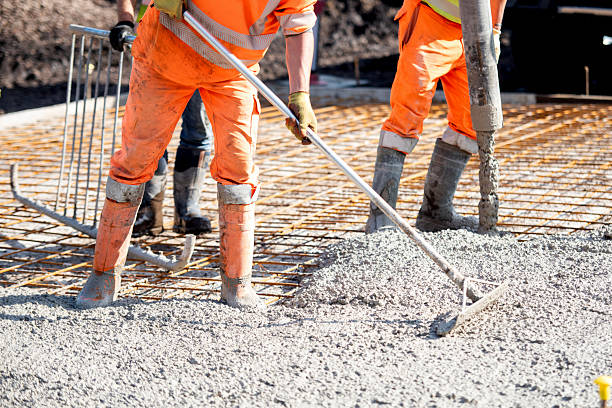 istock Concrete pouring process at a construction site with builders and concrete pump 2232965442