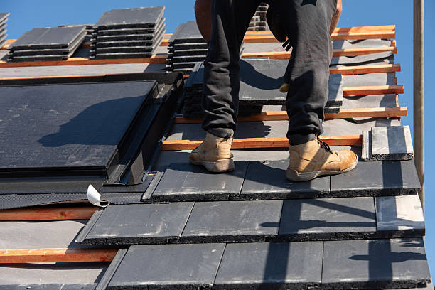 istock Roofer installing roof tiles using nails and hammer 2232965782