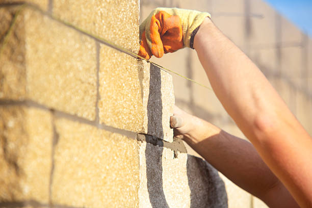 istock Close-up of Bricklayer laying stone blocks on building site 2232966668
