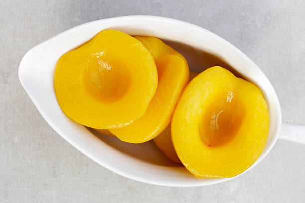 istock Peach halves in syrup. Fruity desserts 2232967100