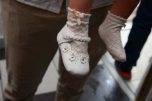 Pairs of little baby shoes, representing motherhood, family and the first moments of childhood. Summer baby shoes