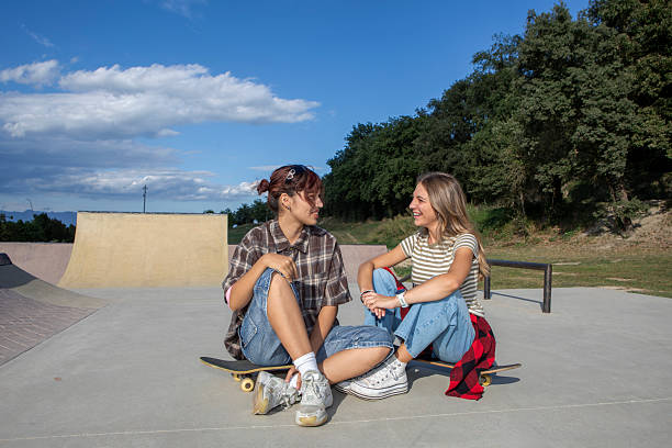 istock Two Young Women with Skateboards at Skatepark 2232974455