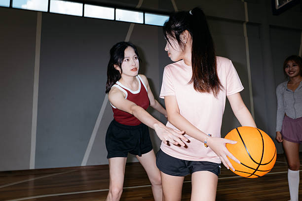 istock Friends playing basketball. 2232976295
