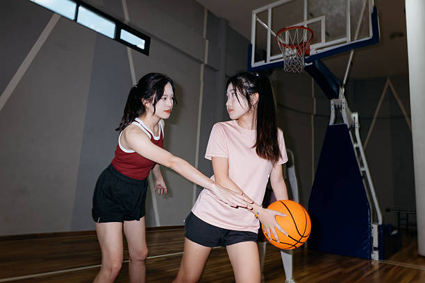 istock Friends playing basketball. 2232976296